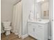 Bright bathroom featuring a white vanity, a tiled floor, and a shower with a curtain at 1436 Belmont Ave, Smyrna, GA 30080
