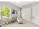 Bright, cheerful bedroom with large window, chair, and playful decor providing a cozy space at 1436 Belmont Ave, Smyrna, GA 30080