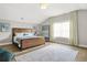 Bedroom featuring hardwood floors, a large rug, and art prints on the walls for decor at 1436 Belmont Ave, Smyrna, GA 30080