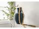 Stylish decor featuring a dark vase and wooden beads on a clear table near a window at 1436 Belmont Ave, Smyrna, GA 30080