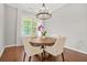 Cozy dining area with wood table, upholstered chairs, natural light, and modern chandelier at 1436 Belmont Ave, Smyrna, GA 30080