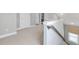 Hallway with carpet, white walls, doors, and a staircase with a window and gray banister at 1436 Belmont Ave, Smyrna, GA 30080