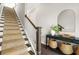 Staircase and hallway featuring a console table with decorative baskets and large mirror at 1436 Belmont Ave, Smyrna, GA 30080