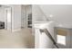 Hallway with carpet, white walls, doors, and a staircase with a window and gray banister at 1436 Belmont Ave, Smyrna, GA 30080