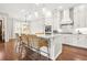 Bright kitchen with white cabinets, granite counters, stainless appliances, and woven counter seating at 1436 Belmont Ave, Smyrna, GA 30080