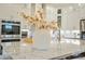 Close-up of a bright kitchen with stainless appliances, granite counters, and decorative floral arrangement at 1436 Belmont Ave, Smyrna, GA 30080