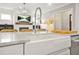 Modern kitchen island features a farmhouse sink, granite countertops, and views of the living area at 1436 Belmont Ave, Smyrna, GA 30080