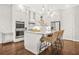 Well-lit kitchen featuring white cabinets, stainless appliances, granite countertops, and a charming breakfast bar at 1436 Belmont Ave, Smyrna, GA 30080