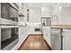 Gourmet kitchen with stainless steel appliances, white cabinets, and a convenient farmhouse sink at 1436 Belmont Ave, Smyrna, GA 30080