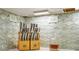 Close-up of a kitchen backsplash with custom tile, a knife block and beverage decanter on the counter at 1436 Belmont Ave, Smyrna, GA 30080