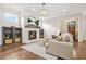 Inviting living room featuring fireplace, hardwood flooring, shiplap accent wall, and lots of natural light at 1436 Belmont Ave, Smyrna, GA 30080