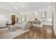 Open-concept living room featuring hardwood floors, fireplace, and seamless transition to the modern kitchen at 1436 Belmont Ave, Smyrna, GA 30080