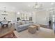 Open-concept living room featuring hardwood floors, fireplace, and seamless transition to the dining room at 1436 Belmont Ave, Smyrna, GA 30080