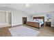 Spacious main bedroom showcasing a wood bed, light-colored walls, and a patterned rug over hardwood floors at 1436 Belmont Ave, Smyrna, GA 30080