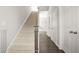 Carpeted staircase with a dark wood banister and white walls, leading to the upper level at 1436 Belmont Ave, Smyrna, GA 30080