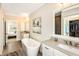 Light-filled bathroom with a modern soaking tub and double vanity sinks at 200 Dawson Dr, Woodstock, GA 30188
