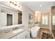 Light-filled bathroom with a modern soaking tub and double vanity sinks at 200 Dawson Dr, Woodstock, GA 30188
