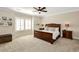 Spacious primary bedroom with a ceiling fan, neutral walls, and carpet at 200 Dawson Dr, Woodstock, GA 30188