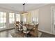 Well-lit dining room featuring a modern light fixture, neutral walls, and classic furnishings at 200 Dawson Dr, Woodstock, GA 30188