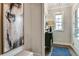 Inviting entryway featuring a bench, artwork, a cabinet, and a window for natural light at 200 Dawson Dr, Woodstock, GA 30188