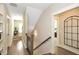 Bright hallway with hardwood floors, staircase, and open doorway to a bedroom at 200 Dawson Dr, Woodstock, GA 30188