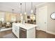 Open-concept kitchen with white cabinets, stainless steel appliances, and an island sink at 200 Dawson Dr, Woodstock, GA 30188