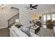 Bright living room showcasing stairs, a ceiling fan, and seamless transition to the open kitchen at 200 Dawson Dr, Woodstock, GA 30188