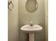 Bathroom with pedestal sink and oval mirror featuring neutral wall color at 3094 Lauren Parc Rd, Decatur, GA 30032