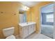 Bathroom featuring a white single sink vanity, mirror, and an adjacent bedroom with blue walls at 3094 Lauren Parc Rd, Decatur, GA 30032