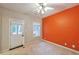 Bright bedroom with an exterior door and an orange accent wall at 3094 Lauren Parc Rd, Decatur, GA 30032
