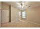 Bedroom with ensuite bathroom features a ceiling fan, closet, and large window at 3094 Lauren Parc Rd, Decatur, GA 30032
