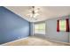 A bright bedroom with a ceiling fan and multiple windows offering natural light and blue accent wall at 3094 Lauren Parc Rd, Decatur, GA 30032