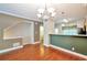 Open dining area with hardwood floors, chandelier, and view to the kitchen at 3094 Lauren Parc Rd, Decatur, GA 30032