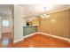 Open dining area with hardwood floors, chandelier, and view to the kitchen at 3094 Lauren Parc Rd, Decatur, GA 30032