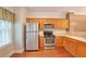 Kitchen features stainless steel refrigerator and gas range with wood cabinetry at 3094 Lauren Parc Rd, Decatur, GA 30032