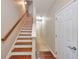 Staircase with hardwood treads, white risers, and a natural wood handrail at 3094 Lauren Parc Rd, Decatur, GA 30032