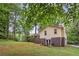 A house with brick on the bottom and siding on top sits in a large grassy yard with mature trees at 358 W West Wind Sw Dr, Lilburn, GA 30047