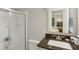 Bathroom featuring a dark countertop and a shower with a glass enclosure at 358 W West Wind Sw Dr, Lilburn, GA 30047