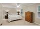 A relaxing bedroom showcases neutral walls, carpet, and a ceiling fan at 358 W West Wind Sw Dr, Lilburn, GA 30047
