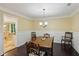 Traditional dining room with hardwood floors, vintage furniture, and natural light at 358 W West Wind Sw Dr, Lilburn, GA 30047