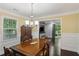 Traditional dining room with dark wood floors, antique buffet, and contemporary chandelier at 358 W West Wind Sw Dr, Lilburn, GA 30047