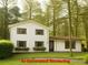 Inviting two-story home with a well-maintained lawn and flower boxes under the windows at 358 W West Wind Sw Dr, Lilburn, GA 30047