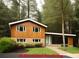 Charming two-story home with a landscaped yard and natural wood siding at 358 W West Wind Sw Dr, Lilburn, GA 30047