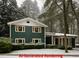 Beautiful two-story home featuring a covered entry and set amidst a snowy, picturesque landscape at 358 W West Wind Sw Dr, Lilburn, GA 30047