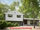 Modern two-story home with a combination of light gray siding and stone accents at 358 W West Wind Sw Dr, Lilburn, GA 30047