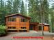 Eye-catching home with natural wood siding, dark window frames, and landscaped front at 358 W West Wind Sw Dr, Lilburn, GA 30047