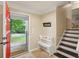 Inviting foyer with tile flooring, a decorative bench, and a view to the front yard at 358 W West Wind Sw Dr, Lilburn, GA 30047