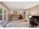 Spacious living room with a couch, desk, stairway, and a door leading outside at 358 W West Wind Sw Dr, Lilburn, GA 30047