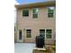 Back of home with sliding doors, concrete patio and outdoor grill at 6001 Oak Bend Ct, Riverdale, GA 30296
