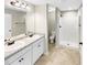 Bathroom featuring double vanity, granite countertop, framed mirror, and stand up shower at 6001 Oak Bend Ct, Riverdale, GA 30296